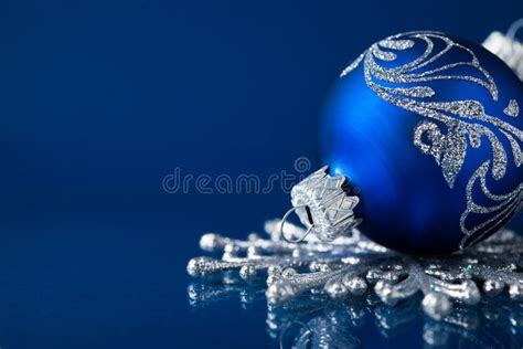 Blue And Silver Christmas Ornaments On Dark Blue Background Stock Image