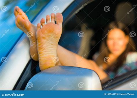 Seductive Woman Having Exposed Bare Feet Out Of Car Window Stock Image