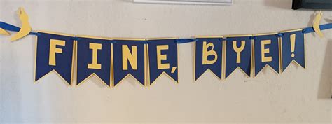 A Blue And Yellow Banner That Says Finnie Byee On The Side Of A Wall