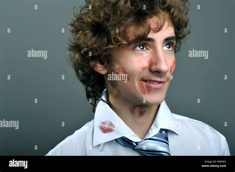 Portrait Of Young Businessman Covered In Lipstick Kisses Stock Photo