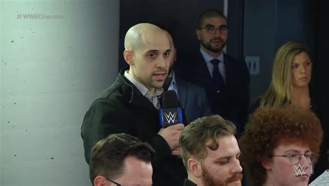 Ariel Helwanis Reaction In The Background As Reporter Brandon Thurston Asks Triple H A Question