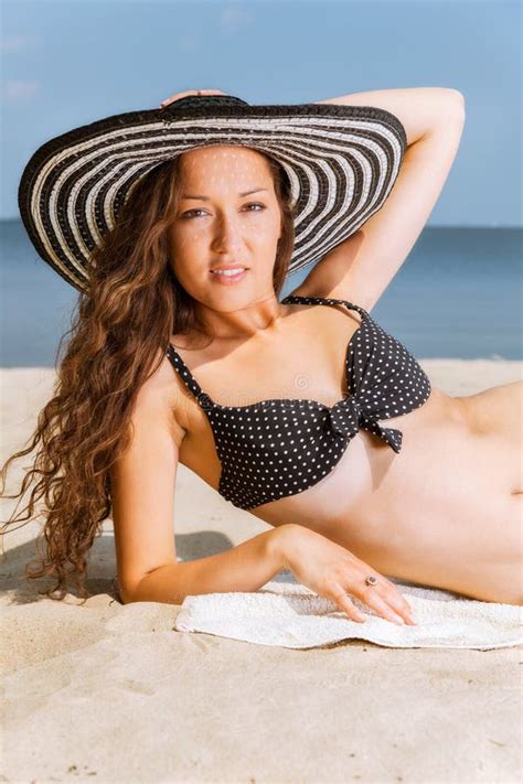 Woman In Bikini Lying Down And Sunbathing On The Beach Stock Image