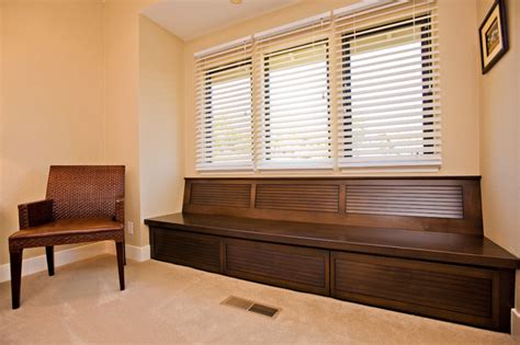 Bright bedroom window seat with a view. Custom Cabinetry Window Seat with Storage in Guest Bedroom