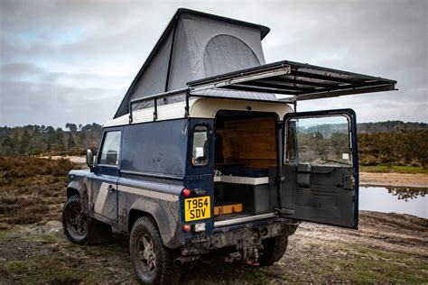 this land rover defender camper s pop up roof unveils a lavish wooden cabin yanko design