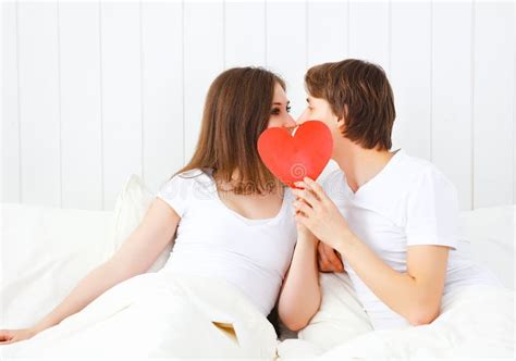 Lover Couple Kissing With A Red Heart In Bed Stock Photo Image Of Bedroom Happy