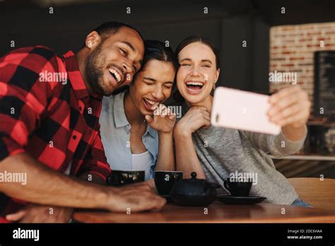 Woman Taking Selfie With Friends In A Cafe Friends In Coffee Shop Having Fun And Taking Selfies