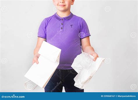 Cute Boy In Very Peri T Short Holding Paper And Plastic Bags