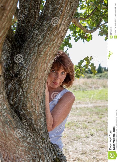 aging woman behind a tree for beauty protection stock image image of care fusion 60135863