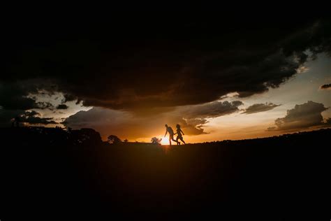 Silhouette Of 2 Person Standing During Sunset · Free Stock Photo