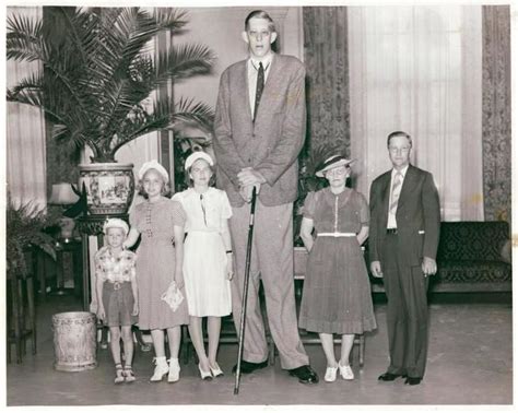 The Worlds Tallest Man Robert Wadlow At Age 21 Standing With His