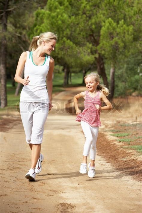 Mother And Daughter Running In Park Stock Photo Colourbox