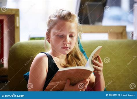 Studying Is Very Important To Her A Cute Blonde Girl Reading A Book At