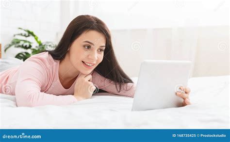 Young Woman Having Video Chat With Friends Via Digital Tablet Stock