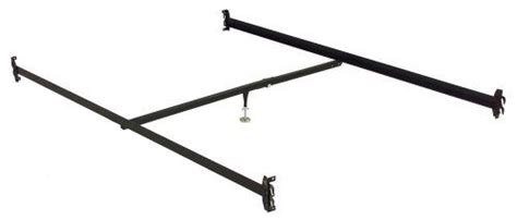 a metal bed frame with four legs and two balls on the bottom one side is black