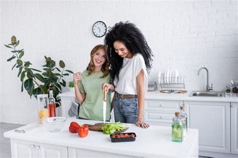 happy multiethnic lesbian couple cooking together stock image image of cheerful lettuce