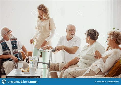 Elders Spending Time In The Common Room Of The Care Home Stock Photo