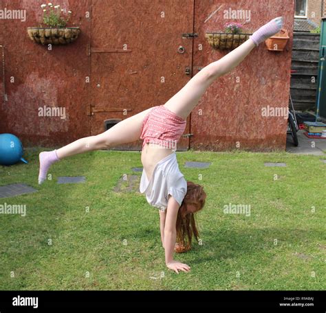 Young Girl Doing Gymnastics Handstand In The Splits With Long Ginger