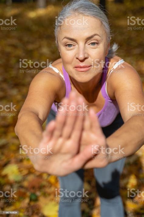 Fit Mature Caucasian Woman Doing Stretching Exercises Stock Photo