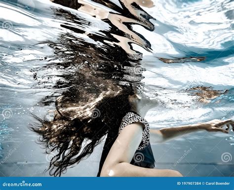 A Girl`s Long Hair Flowing Underwater And Reflections On The Undersurface Of The Water Stock