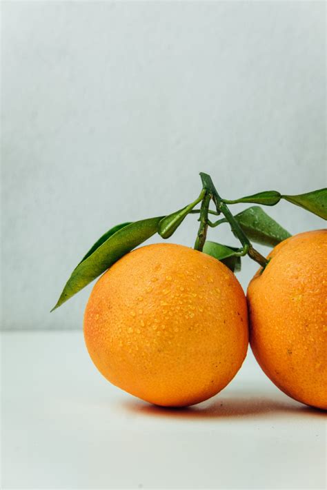 Two Orange Fruits On Table With Images