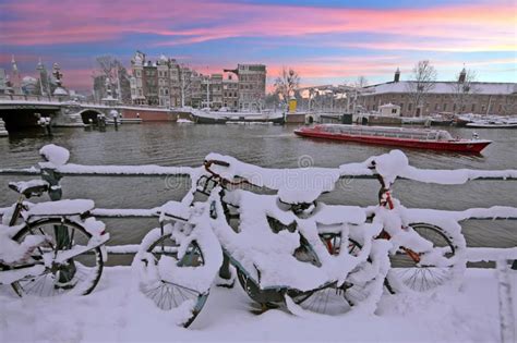 Sunset In Snowy Amsterdam In The Netherlands At The Amstel Stock Photo