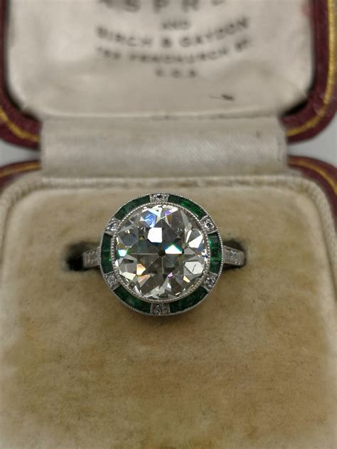 Milgraining, filigree detail, and scrollwork. An Art Deco Diamond, Emerald And Platinum Ring 3.64 Carat | 697513 | Sellingantiques.co.uk