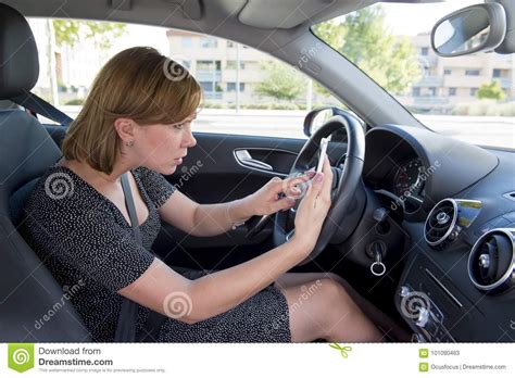 Worried And Stressed Woman Driving Car While Texting On Mobile Phone