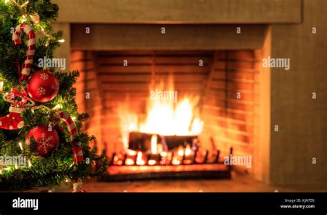 Christmas Tree Close Up On Blurred Burning Fireplace Background Stock