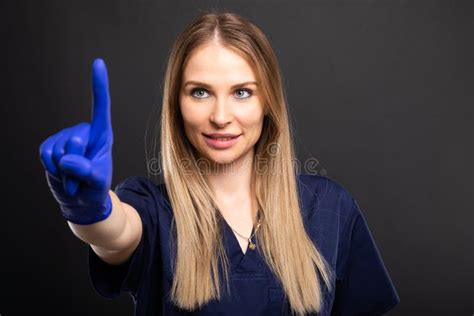 beautiful female dentist wearing scrubs showing index finger stock image image of medicine