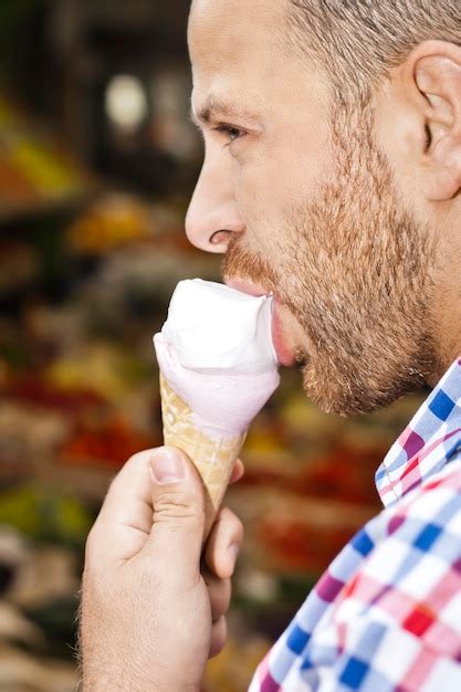 Premium Photo Close Up Of Man Licking Ice Cream