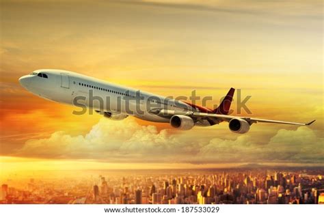 Airplane Flying Above City Sunset Stock Photo Edit Now 187533029