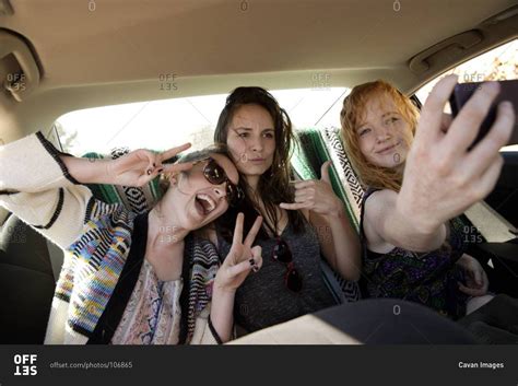 Women Taking Selfies In A Backseat Of A Car Stock Photo Offset