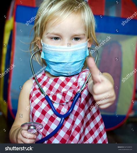 Little Girl Playing Doctor Her Doll Stock Photo Edit Now 567220072