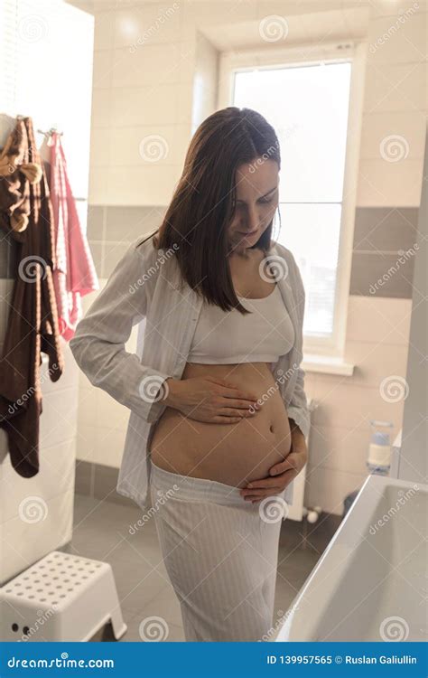 Young Pregnant Girl In Bathroom Touching Belly Stock Image Image Of Hand Pregnancy 139957565