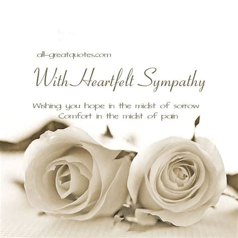 Two White Roses Sitting On Top Of A Table Next To Each Other With The Words Sympathy Written