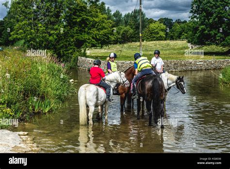 A Group Of Horse Riders Congregate In A Stream Hi Res Stock Photography
