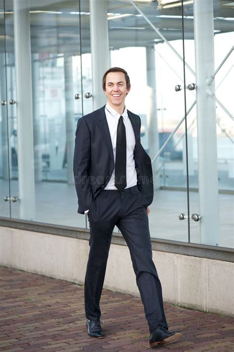 Happy Businessman In Suit Walking On Sidewalk In The City Stock Photos