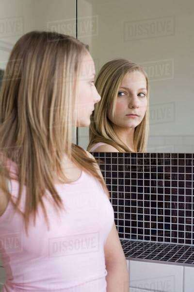 A Teenage Girl Looking In A Mirror Stock Photo Dissolve