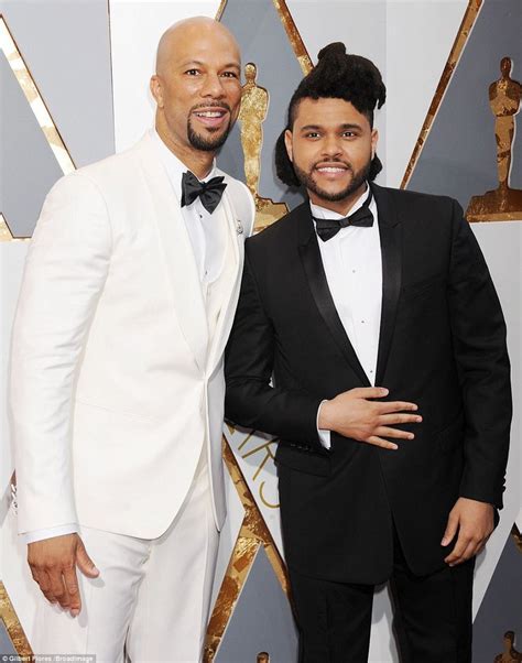 Two Men In Tuxedos Posing On The Red Carpet At An Oscars Event