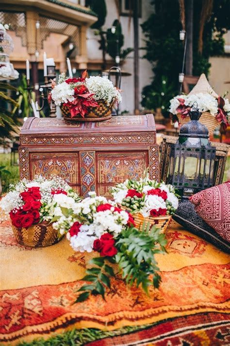 Moroccan Wedding Decor With Red Florals Lanterns And Rugs Wedding