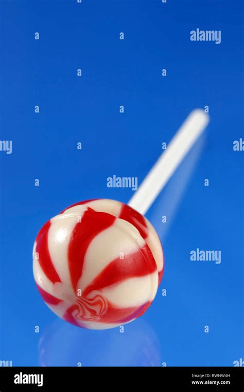 Colorful Red White Stripy Lollipop Isolated On Blue Background Stock