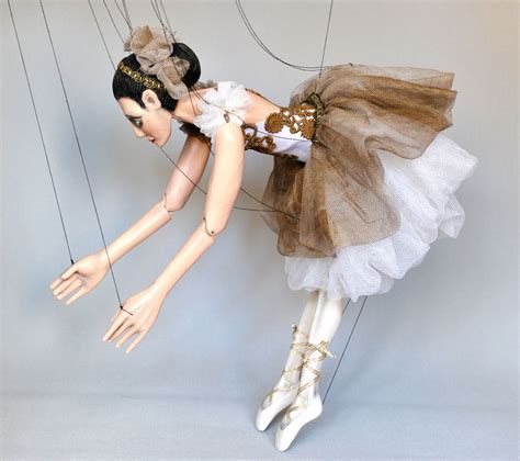 A Mannequin Dressed As A Ballerina Is Suspended By Strings