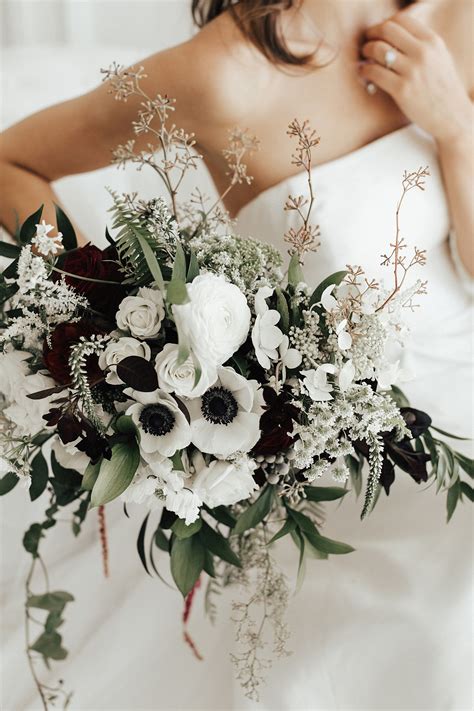 White Anemone Bouquet With Accents Of Dark Greenery And Burgundy