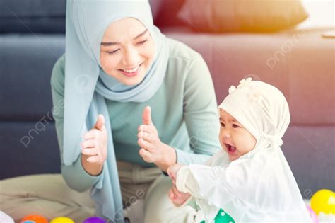 Background Ibu Muslim Senyum Bahagia Menikmati Bermain Dengan Bayinya