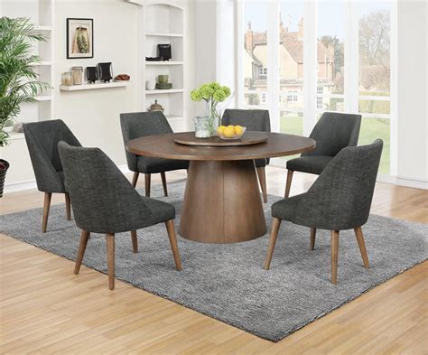 But in this case, the addition of the wood leaf adds an important detail, tying in the chairs to the table. Beverly Mid-Century Modern Style Round Metal Dining Table