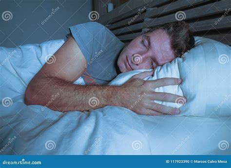 Young Attractive And Handsome Tired Man On His 30s Or 40s In Bed Sleeping Peacefully And Relaxed