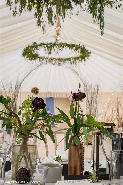 hanging floral rings and an arch dividing the marquee adds to the drama within the venue a