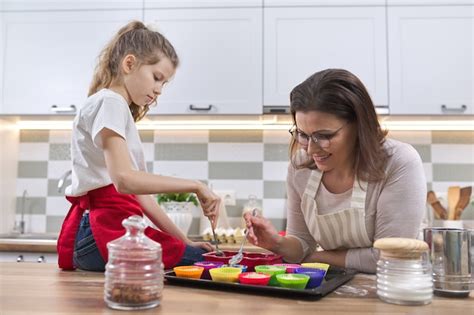 Premium Photo Mother And Daughter Preparing Cupcakes Together At Home In Kitchen