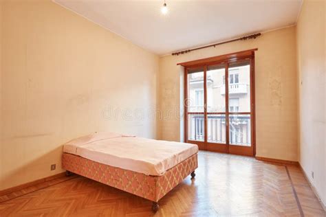 Bedroom With Pink Bed Cover In Old Apartment Interior Stock Photo