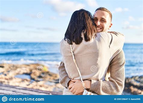 man and woman couple smiling confident hugging each other standing at seaside stock image